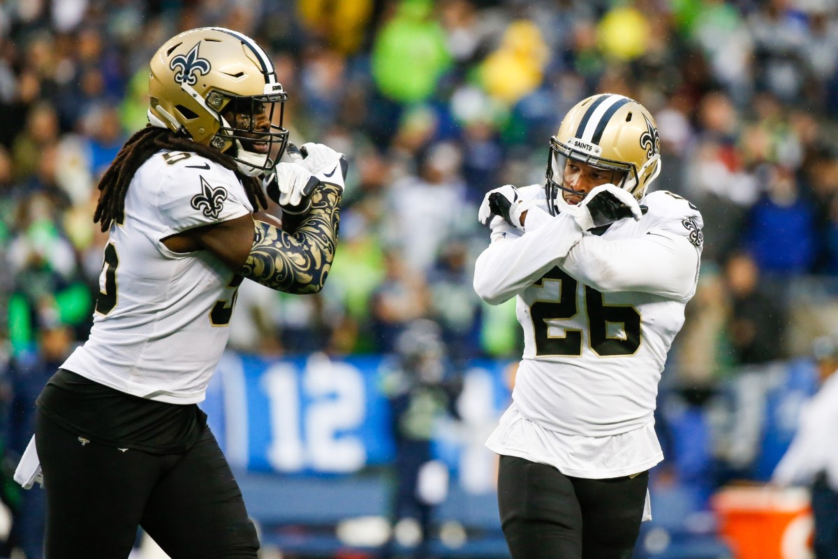 New Orleans Saints cornerback P.J. Williams (26) and linebacker Demario Davis (56) celebrate following against the Seattle Seahawks. Mandatory Credit: Joe Nicholson-USA TODAY Sports